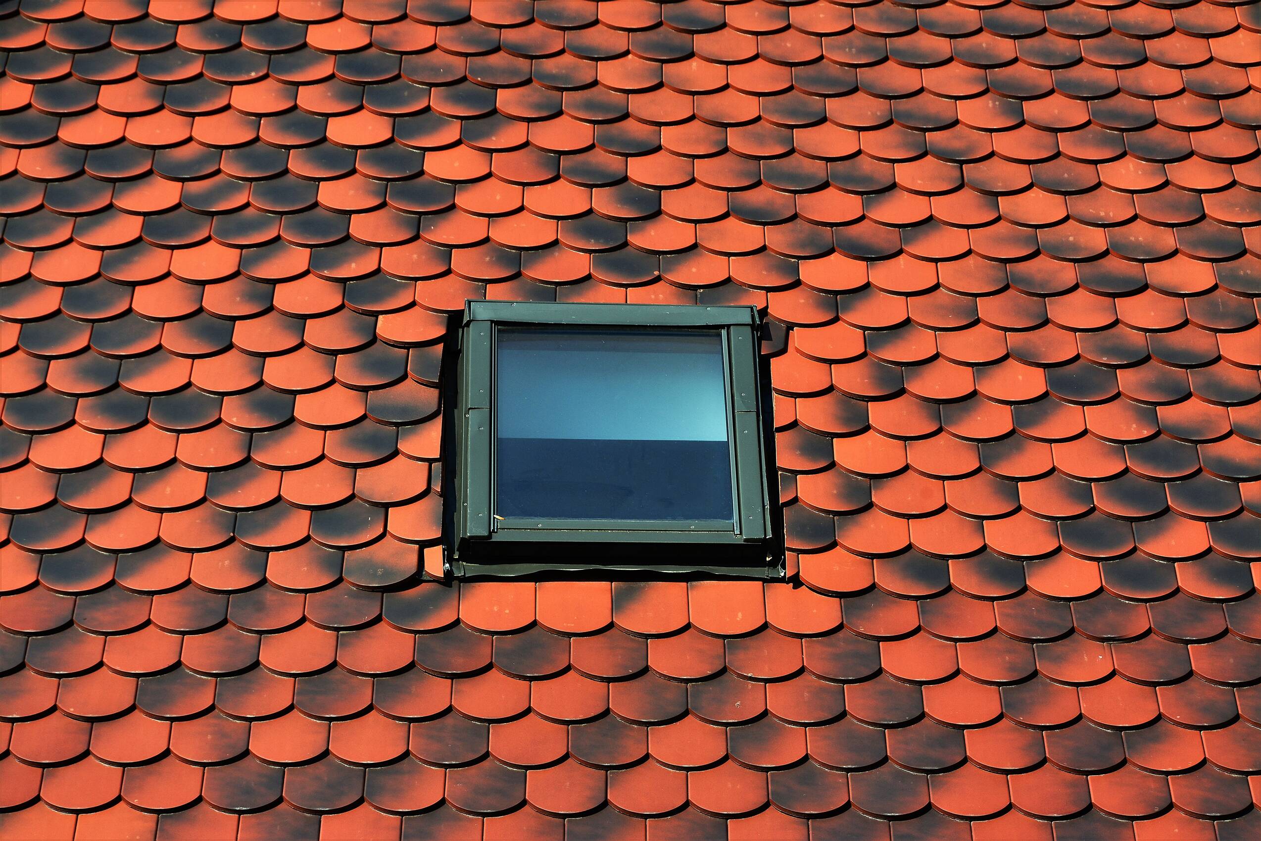 View of an orange colored tiled roof with a window 2026 03 18 09 25 20 utc