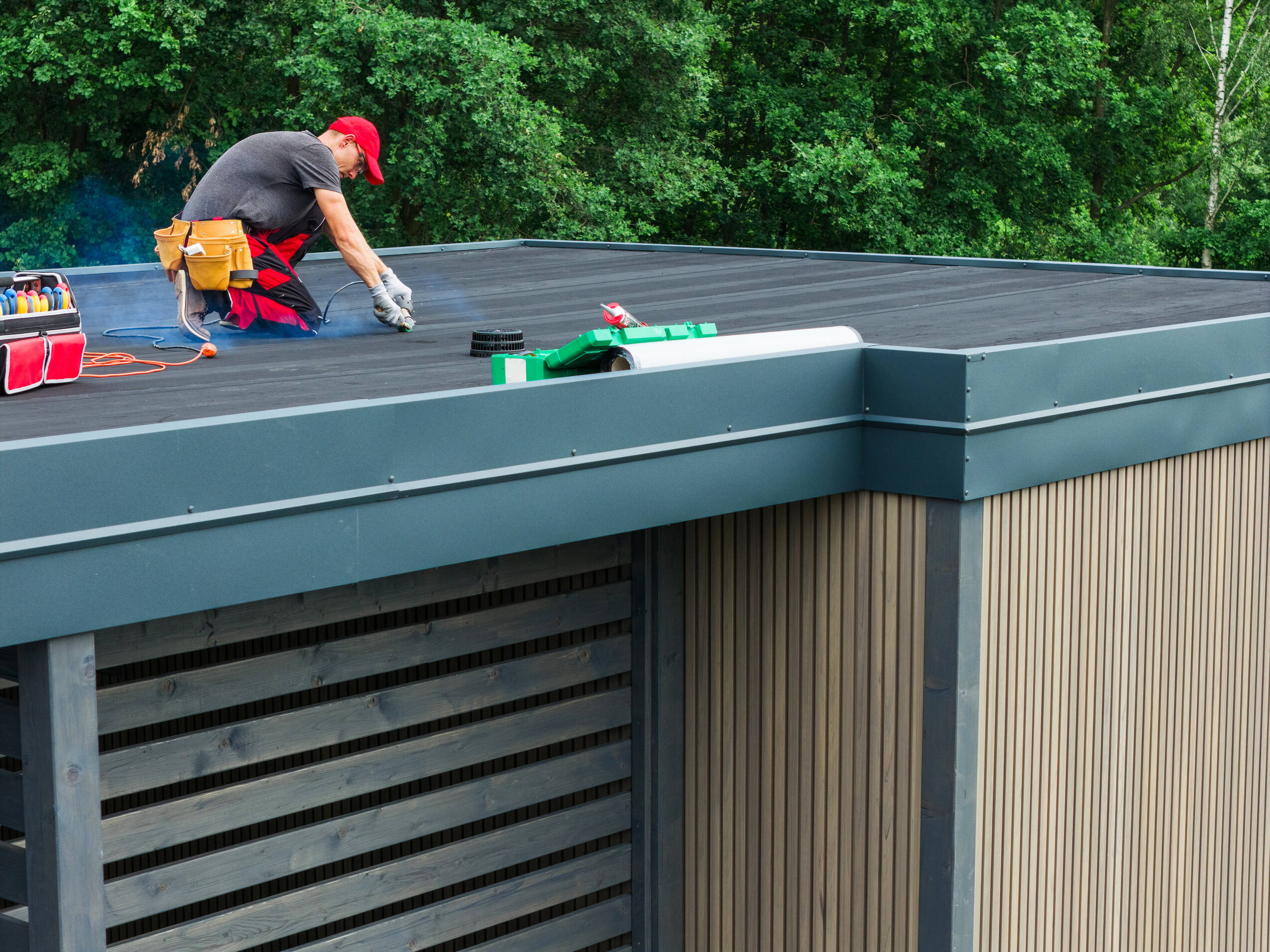 Roofer repairs seam on flat roof building 2026 03 24 06 26 37 utc